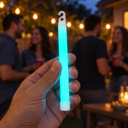 Lifestyle illustration of an adult holding a aqua glow stick at an evening party.