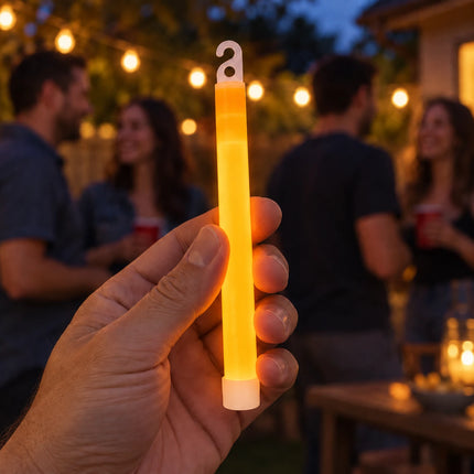 Lifestyle illustration of an adult holding a orange glow stick at an evening party.