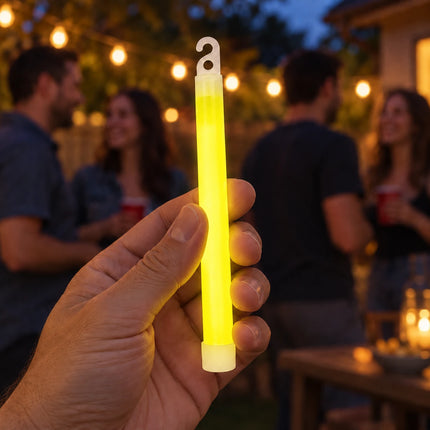 Lifestyle illustration of an adult holding a yellow glow stick at an evening party.