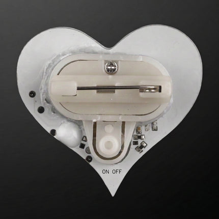 Back of LED heart pin showing safety pin attachment and on-off button
