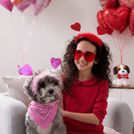 Woman in red outfit with heart head bopper and shaped sunglasses