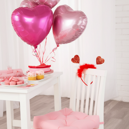 White chair with red heart head bopper